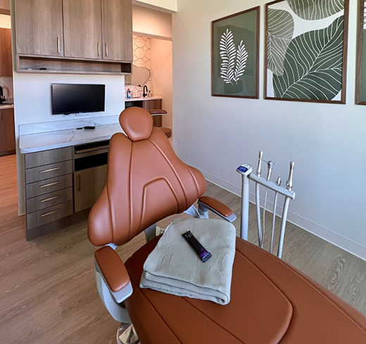 Towel and remote sitting on empty dental chair