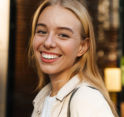 Close-up of woman in white shirt smiling and walking