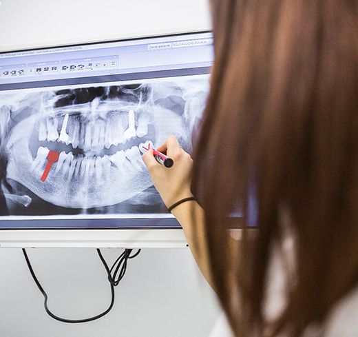 Dental team member looking at dental X ray