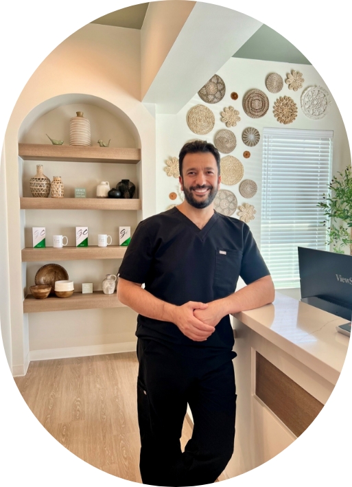 Doctor Ifraitekh smiling with arms folded