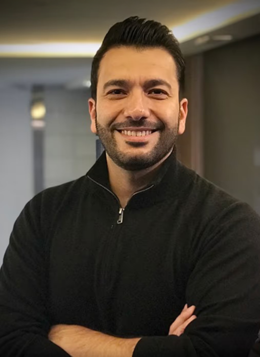 Dr. Ifraitekh smiling with arms folded