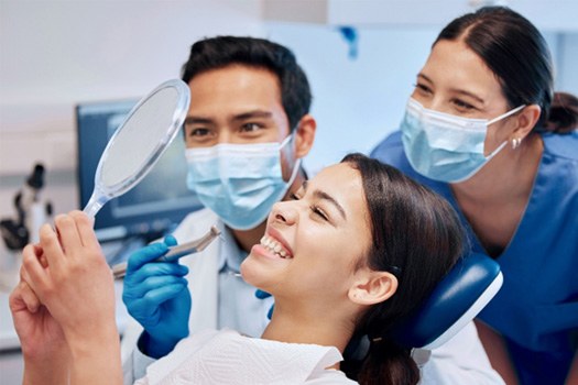 Patient in Teravista holding cheek at dentist