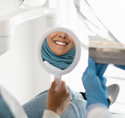 POV shot of patient checking smile in mirror
